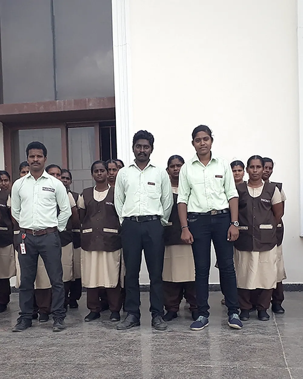 Falcon Eye housekeeping and facility team lined up at a client site