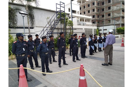 Falcon Eye security personnel lined up for an outdoor team briefing